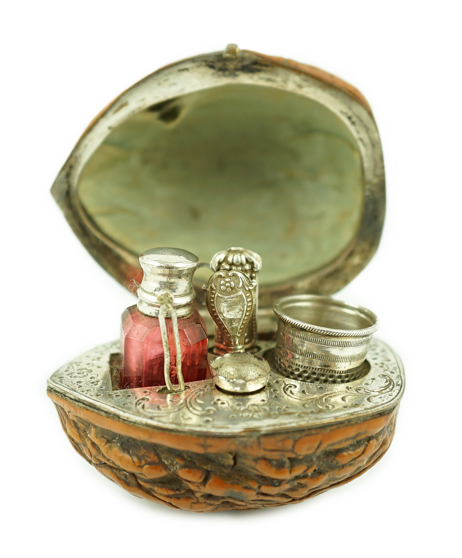 A 19th century French novelty etui case, modelled as a walnut, containing six silver or silver mounted implements